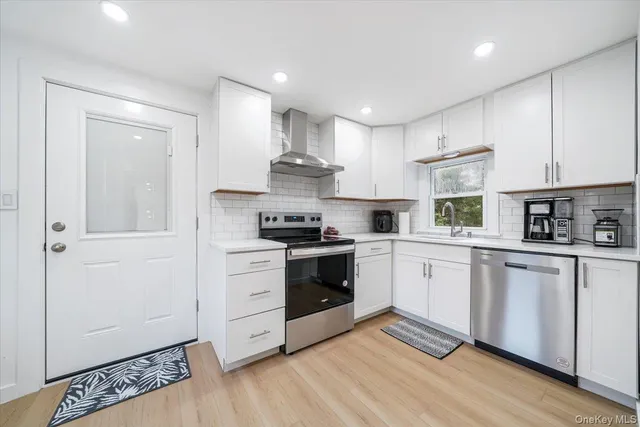 a kitchen with granite countertop white cabinets and white appliances