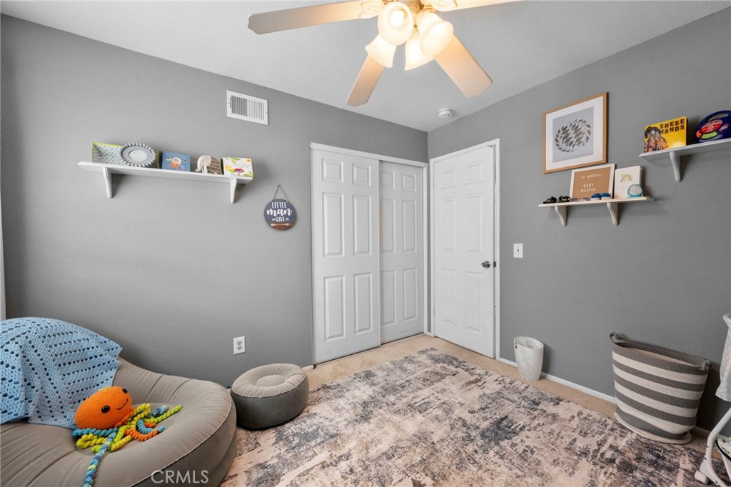 3684 North Veronica Court Rialto, CA 92377 - Photo 11 of 75 a bedroom with a bed and a chandelier