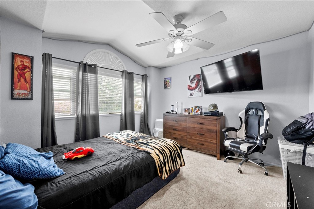 3684 North Veronica Court Rialto, CA 92377 - Photo 16 of 75 a bedroom with a bed and flat screen tv