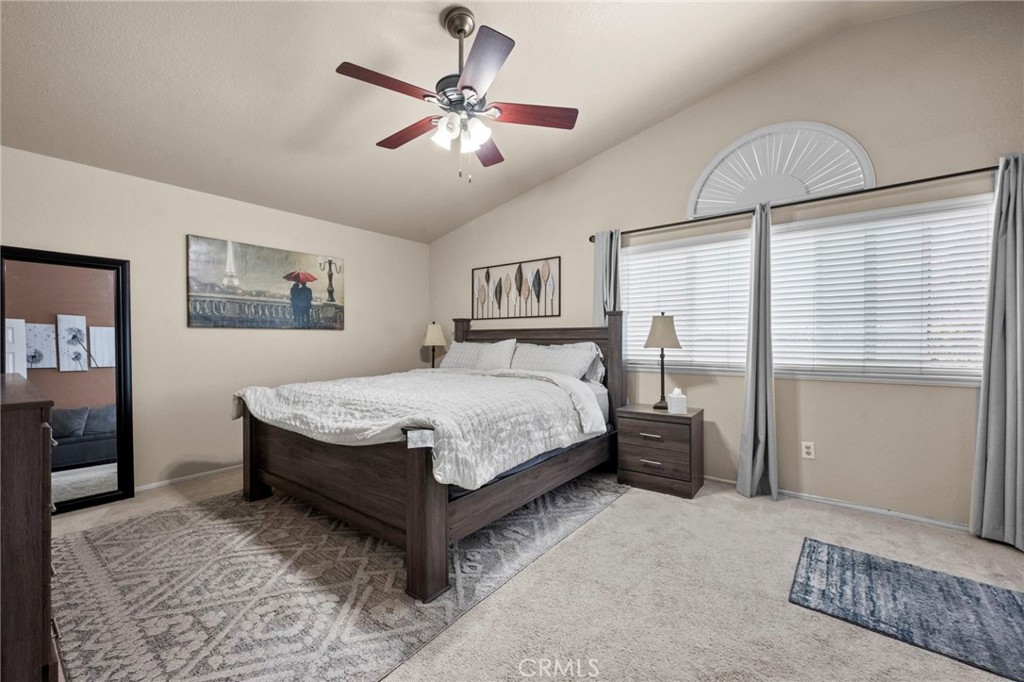 3684 North Veronica Court Rialto, CA 92377 - Photo 18 of 75 a bedroom with a large bed and a chandelier