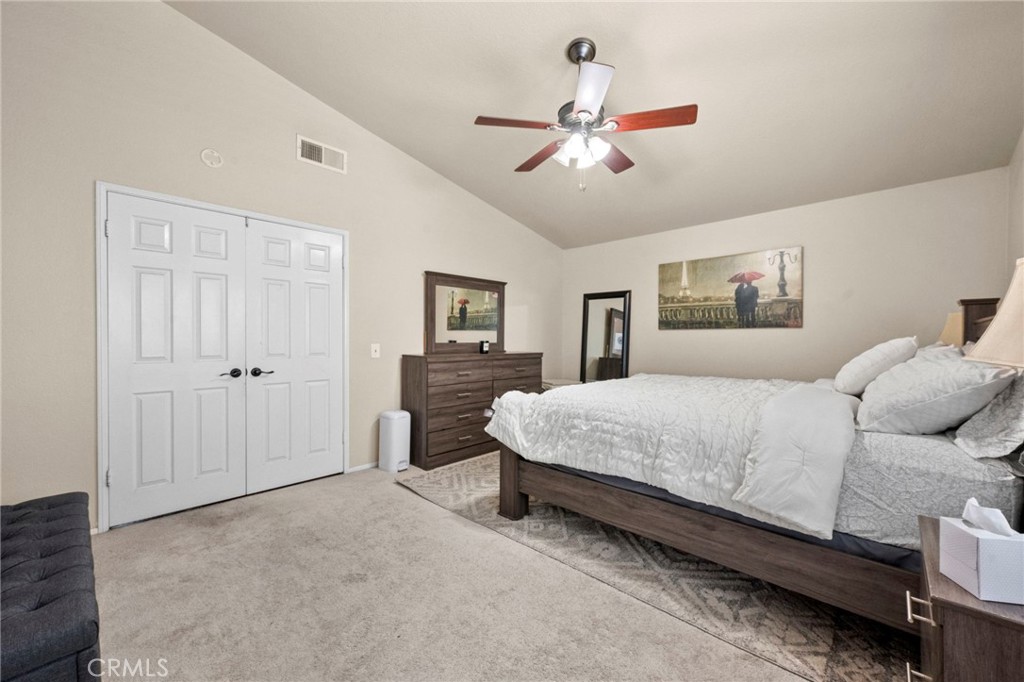 3684 North Veronica Court Rialto, CA 92377 - Photo 19 of 75 a bedroom with a large bed chandelier and a window