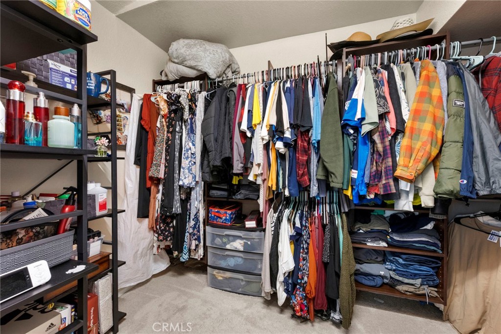 3684 North Veronica Court Rialto, CA 92377 - Photo 24 of 75 a view of walk in closet with clothes and shoes
