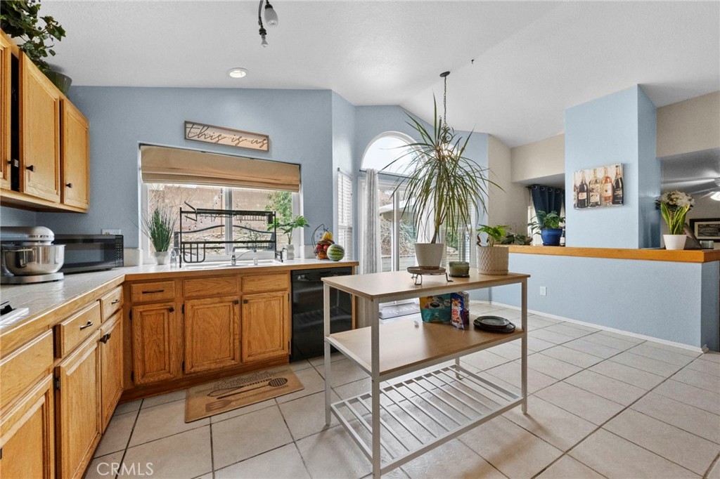 3684 North Veronica Court Rialto, CA 92377 - Photo 37 of 75 a open kitchen with stainless steel appliances granite countertop a stove a sink a oven a dining table and chairs with wooden floor