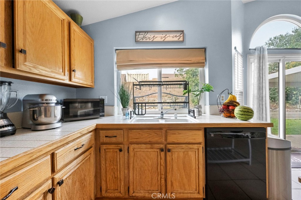 3684 North Veronica Court Rialto, CA 92377 - Photo 39 of 75 a kitchen with stainless steel appliances granite countertop a sink window and cabinets