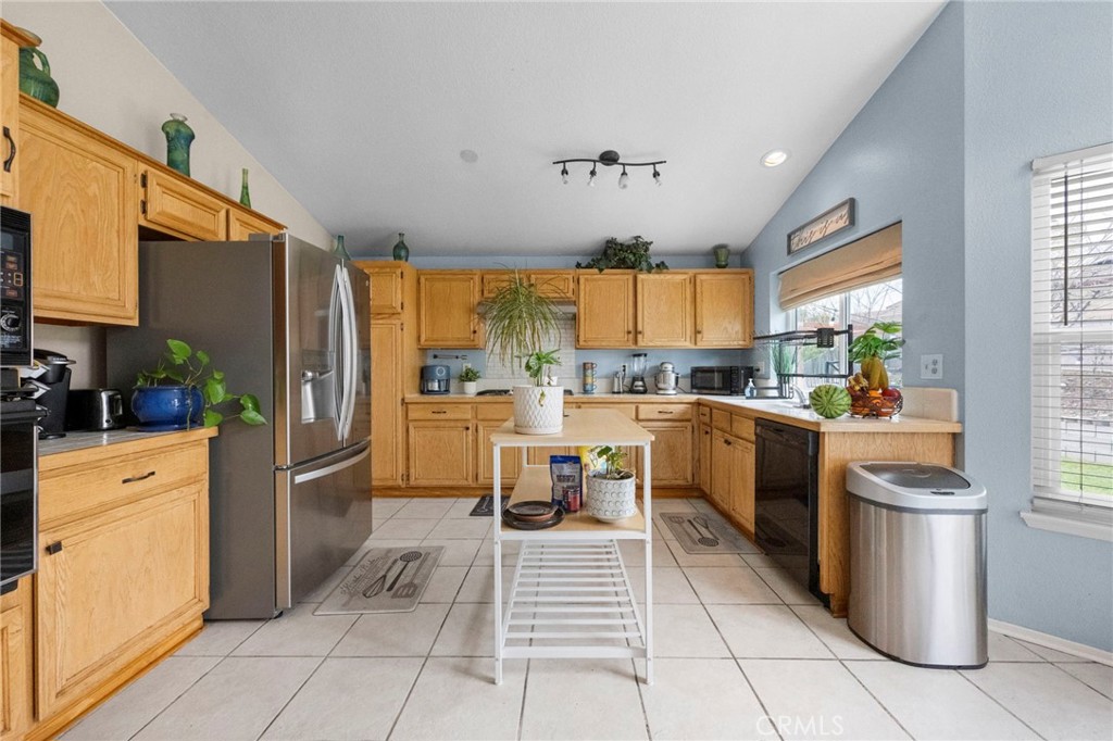 3684 North Veronica Court Rialto, CA 92377 - Photo 40 of 75 a kitchen with stainless steel appliances a refrigerator sink and cabinets