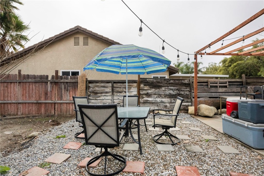 3684 North Veronica Court Rialto, CA 92377 - Photo 62 of 75 a view of a patio with a table and chairs under an umbrella