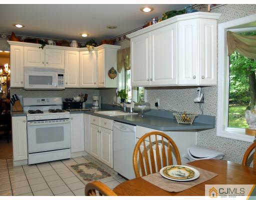 5 Sherwood Road Edison, NJ 08820 - Photo 4 of 10 a kitchen with a stove a sink and a microwave