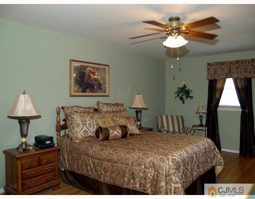 5 Sherwood Road Edison, NJ 08820 - Photo 6 of 10 a bedroom with a bed and a chandelier