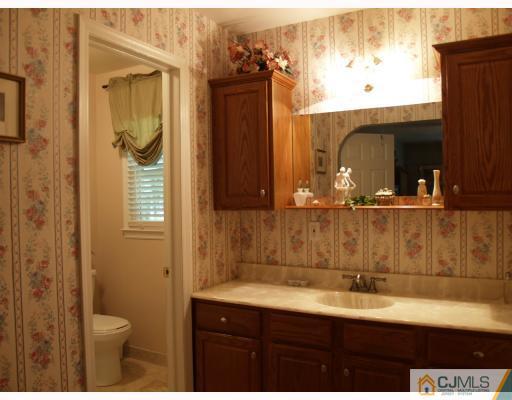 5 Sherwood Road Edison, NJ 08820 - Photo 7 of 10 a bathroom with a sink and a mirror