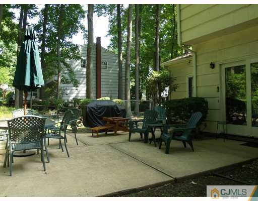 5 Sherwood Road Edison, NJ 08820 - Photo 9 of 10 a view of a patio with table and chairs and potted plants