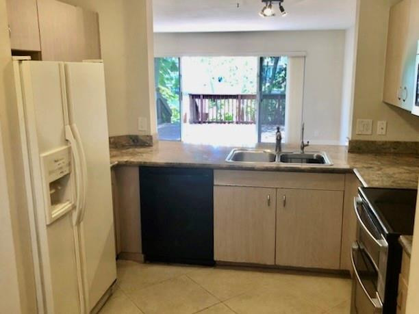 2000 Riverside Place, Unit 4 Wilton Manors, FL 33305 - Photo 13 of 40 a kitchen with stainless steel appliances granite countertop a refrigerator and a sink
