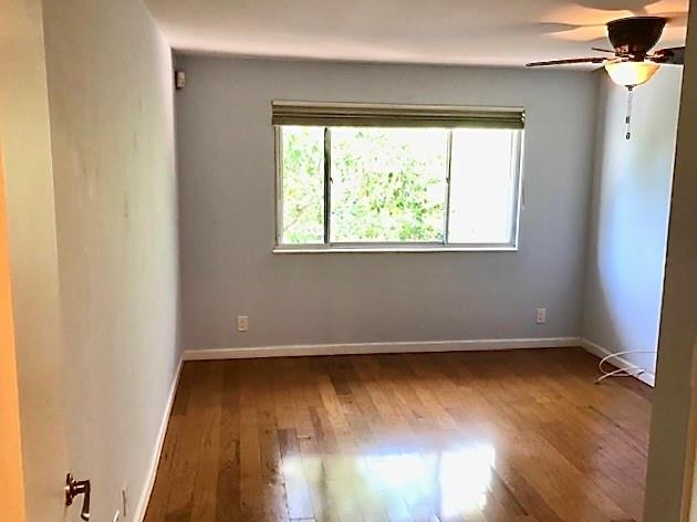 2000 Riverside Place, Unit 4 Wilton Manors, FL 33305 - Photo 29 of 40 an empty room with wooden floor and windows
