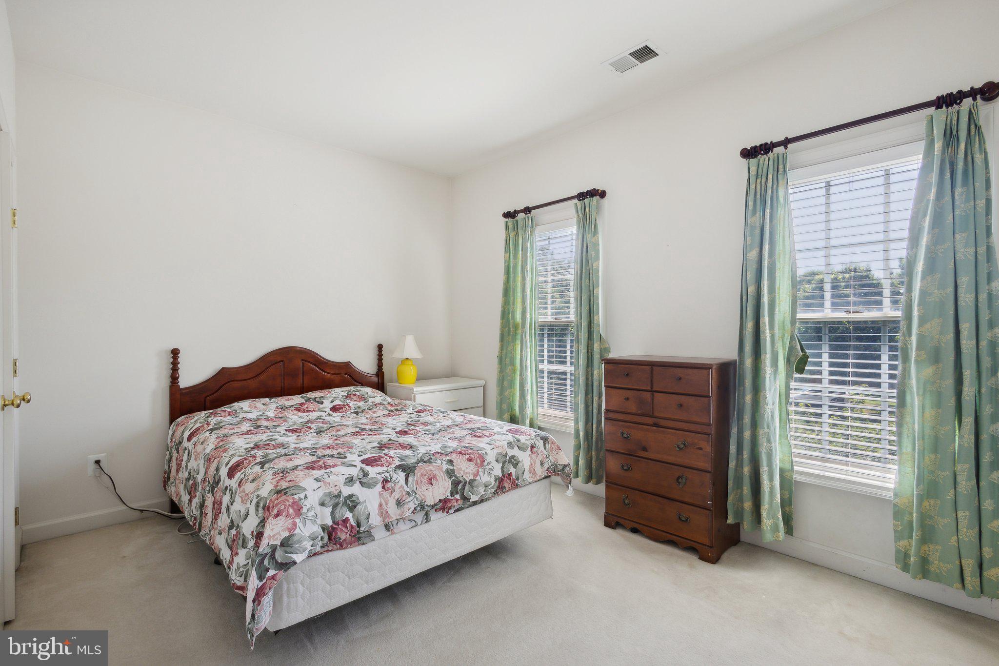 7102 Clarkson Drive Springfield, VA 22150 - Photo 16 of 26 a bedroom with a bed and a cabinets