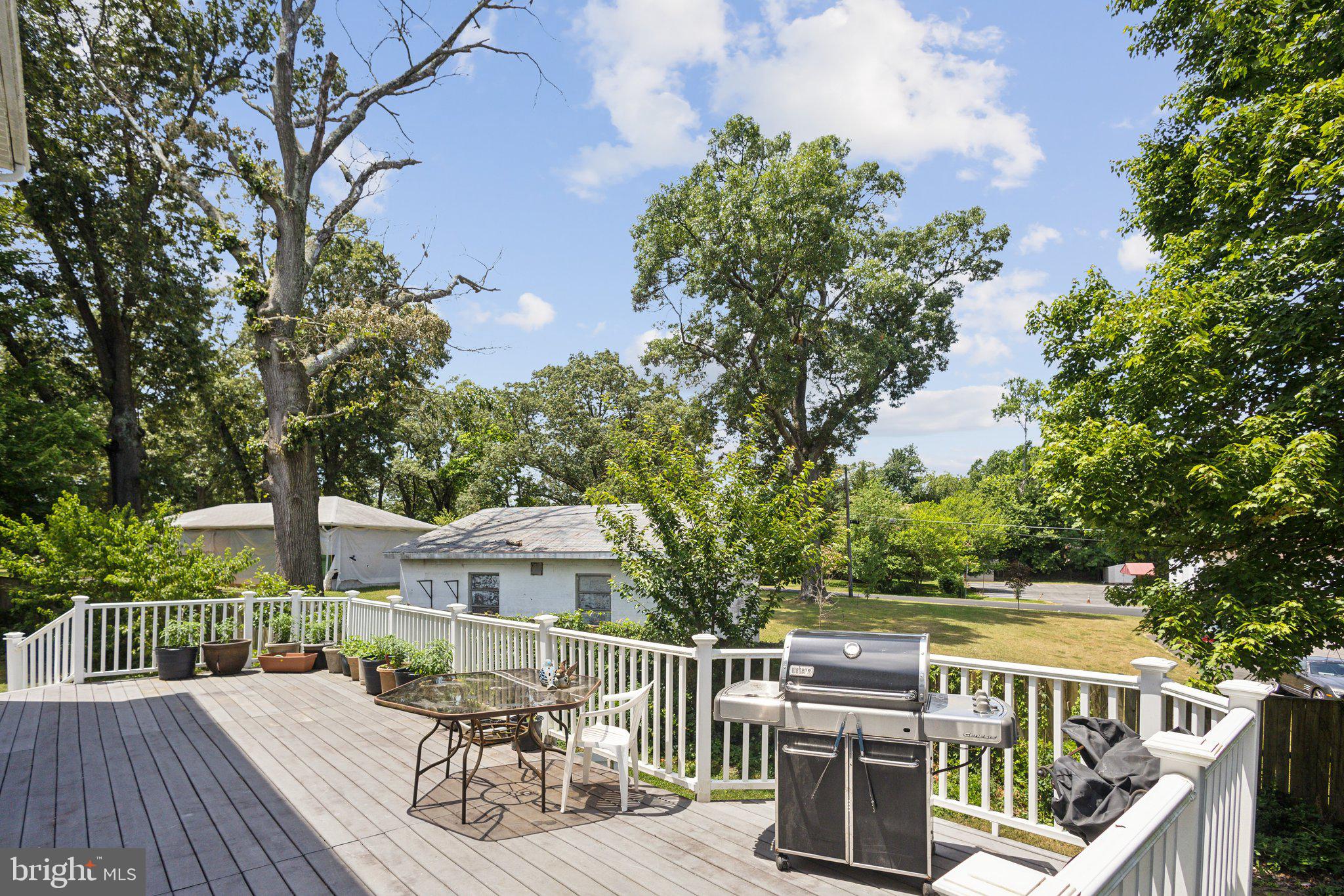 7102 Clarkson Drive Springfield, VA 22150 - Photo 19 of 26 a view of a deck with furniture and trees around