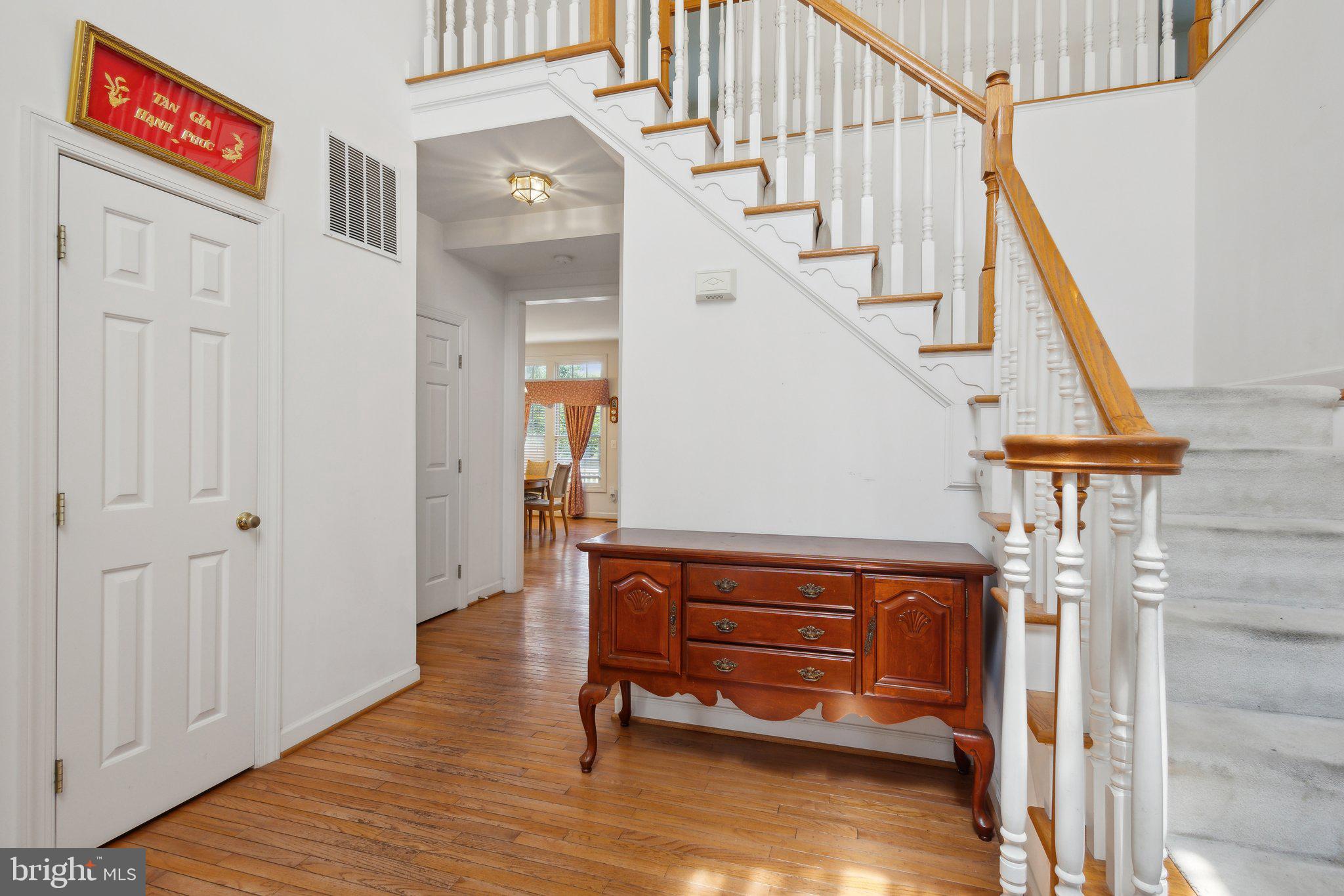 7102 Clarkson Drive Springfield, VA 22150 - Photo 2 of 26 a view of entryway with wooden floor and stairs