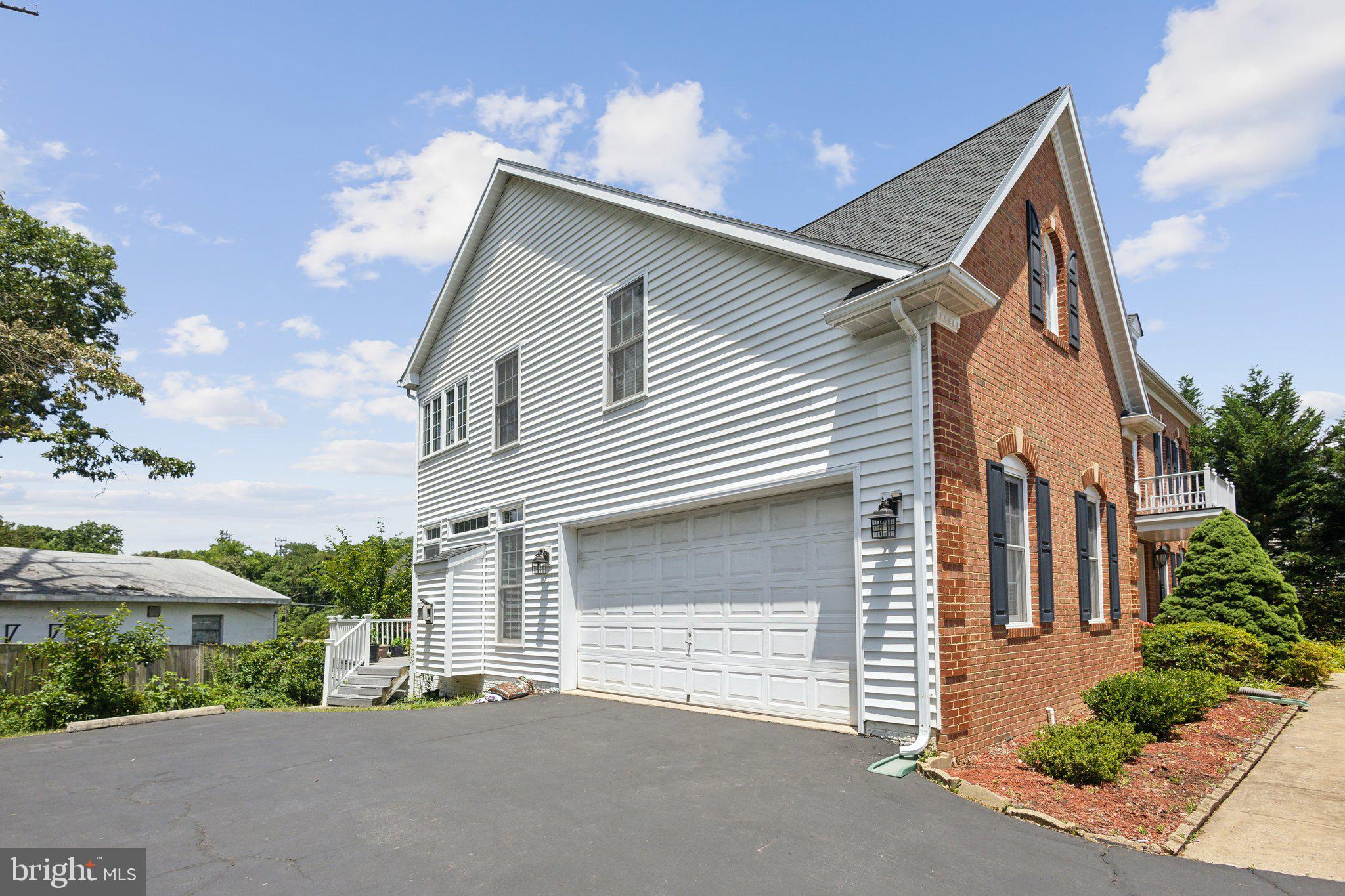 7102 Clarkson Drive Springfield, VA 22150 - Photo 22 of 26 a front view of a house with a yard and garage