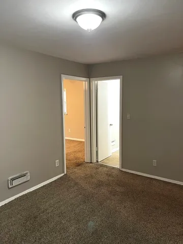 an empty room with windows and closet