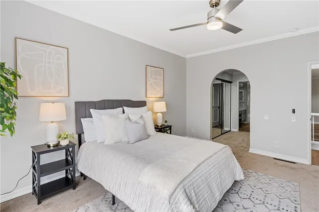 a bedroom with a bed and a chandelier