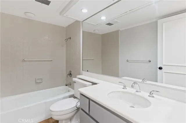 an empty room with a window and a kitchen