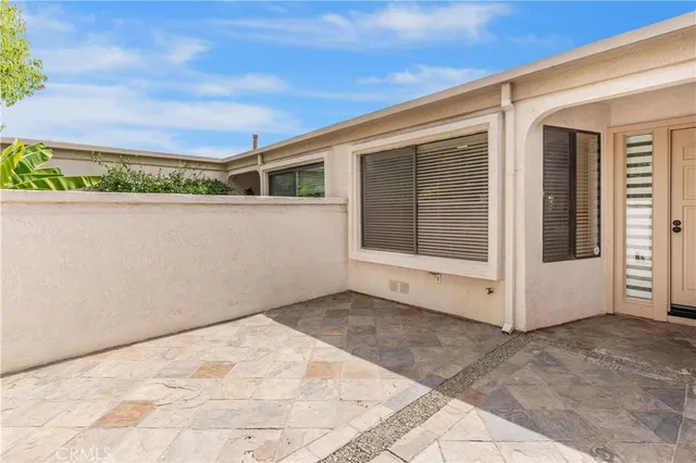 a view of a hallway with wooden floor and entryway