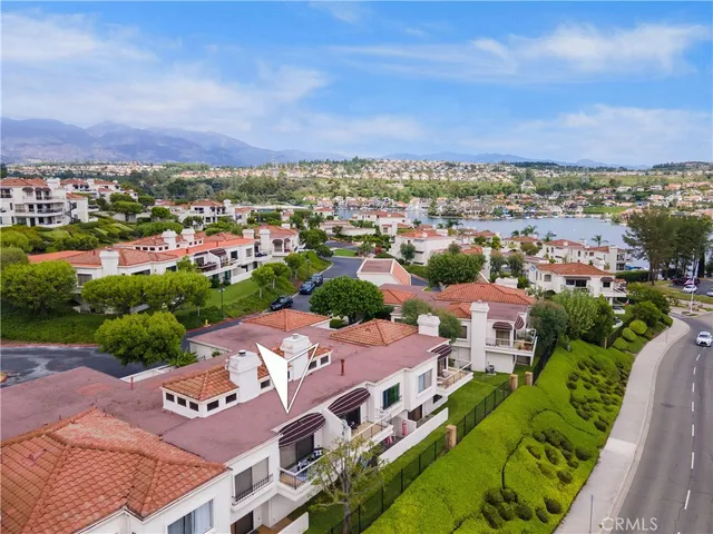 an aerial view of a city with lots of residential buildings lake and ocean view