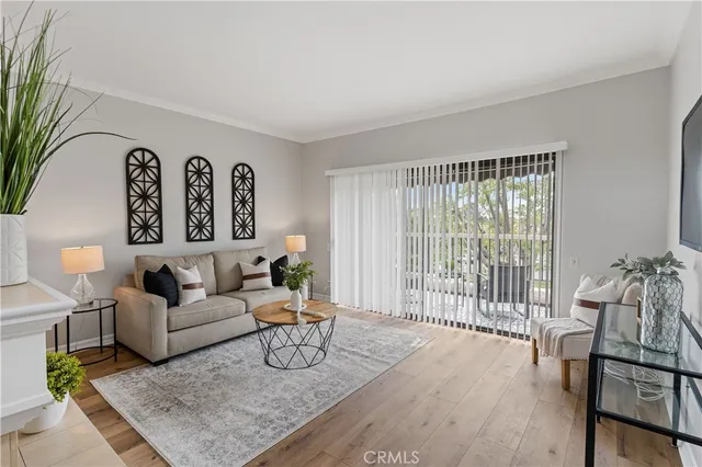 a living room with furniture and a floor to ceiling window