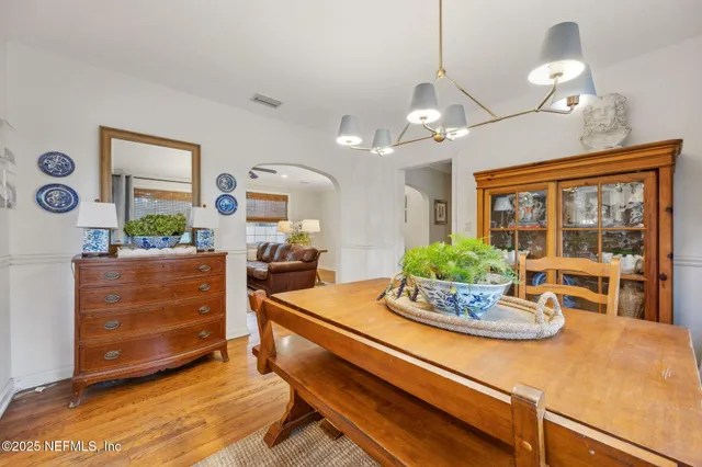 a kitchen with a stove and a table chair