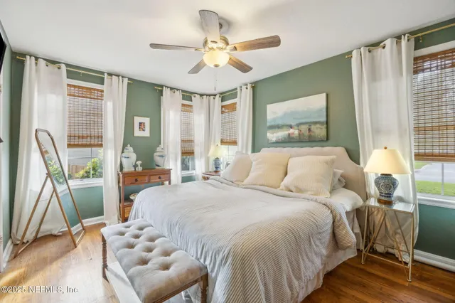 a bedroom with a bed and a large window