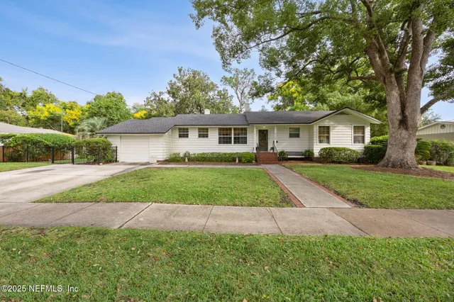 a view of house that has a yard