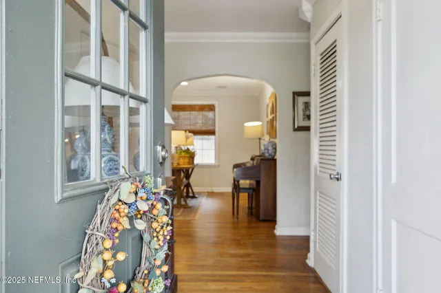 a very nice looking room with wooden floor and a large window