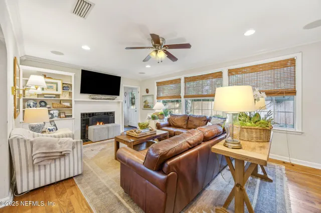 a living room with furniture fireplace and a flat screen tv
