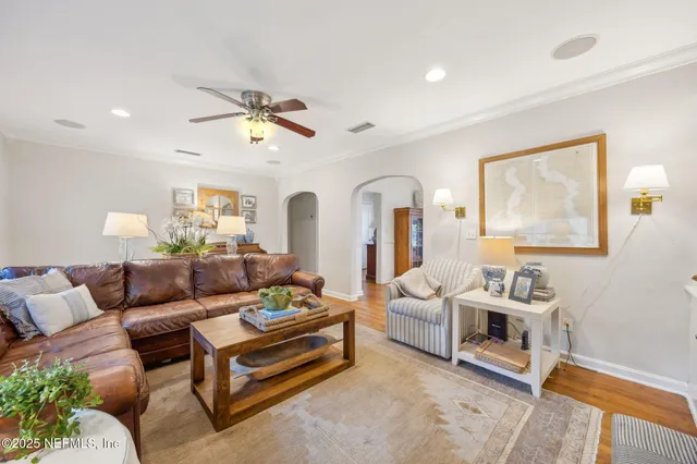 a living room with furniture ceiling fan and a rug