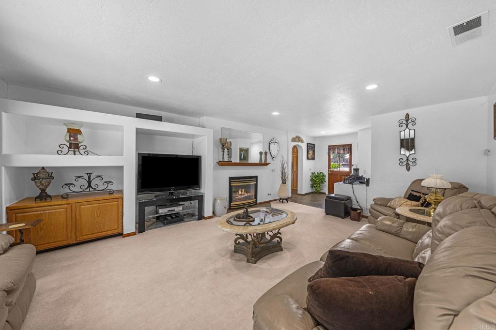 30265 Miller Road Valley Center, CA 92082 - Photo 14 of 56 a living room with furniture and a flat screen tv