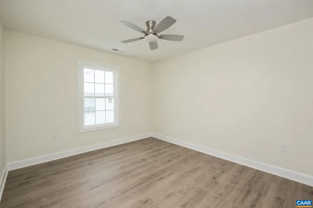 a spacious bathroom with a double vanity sink a toilet and a window