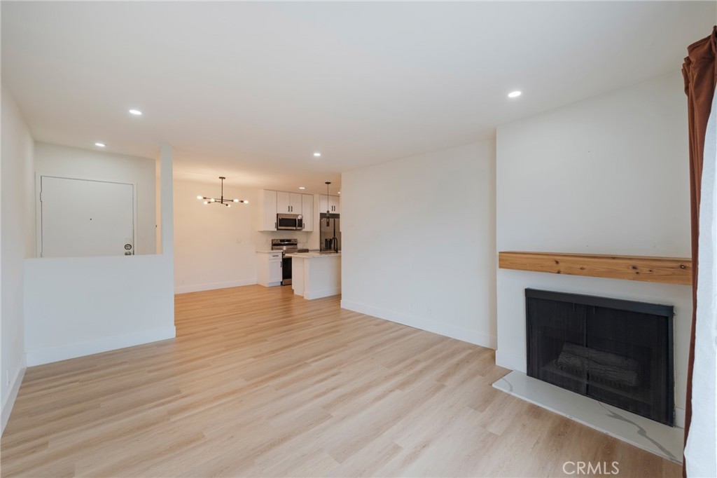 8163 Redlands Street, Unit 73 Playa del Rey, CA 90293 - Photo 4 of 23 a view of kitchen and empty room with wooden floor