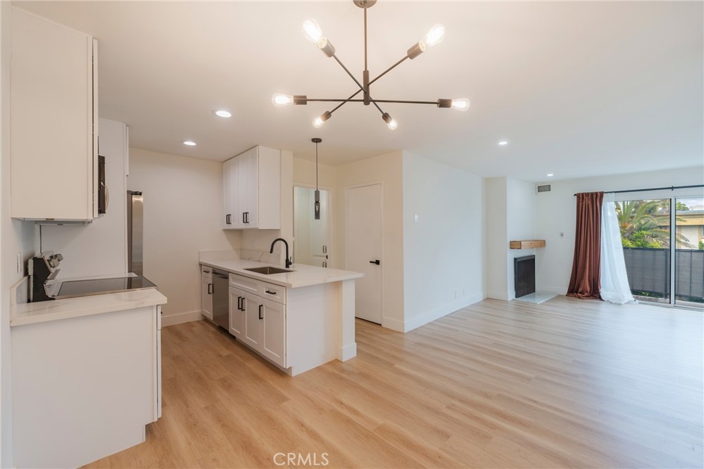8163 Redlands Street, Unit 73 Playa del Rey, CA 90293 - Photo 5 of 23 a large white kitchen with a stove a sink and a refrigerator