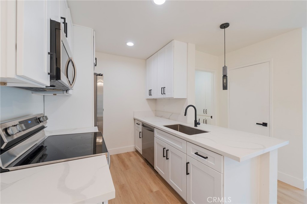 8163 Redlands Street, Unit 73 Playa del Rey, CA 90293 - Photo 7 of 23 a kitchen with a sink a stove and cabinets