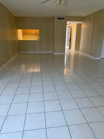 a view of a livingroom with wooden floor and a window