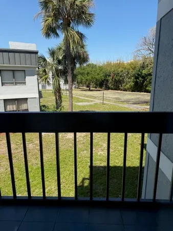 a view of a room with a window and cabinets
