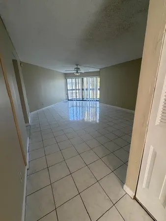 a view of an empty room and staircase