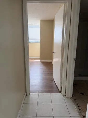 a kitchen with a stove top oven and cabinets