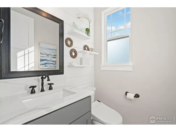 a bathroom with a sink mirror and shower