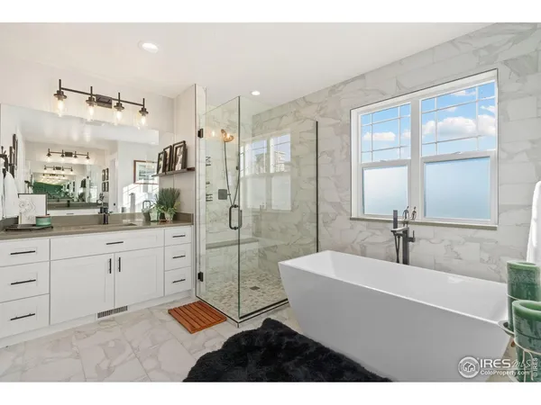 a spacious bathroom with a shower sink and mirror
