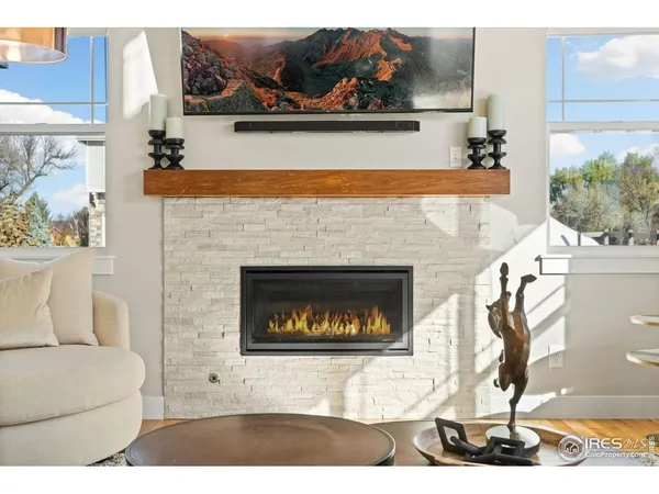 a living room with furniture a rug and white walls