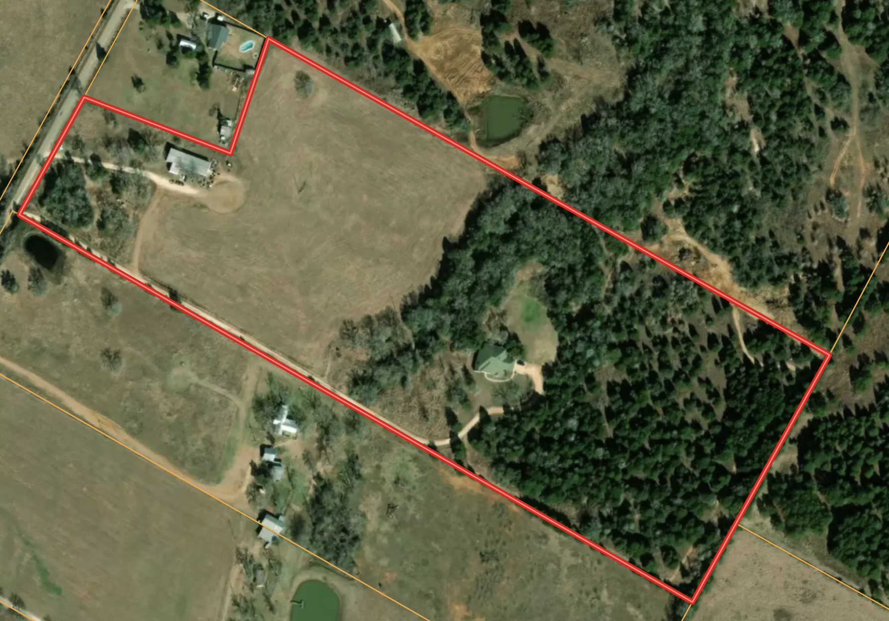 741 Knobbs Road McDade, TX 78650 - Photo 2 of 38 An aerial perspective showcases a vast rural landscape with varied terrain and established structures.