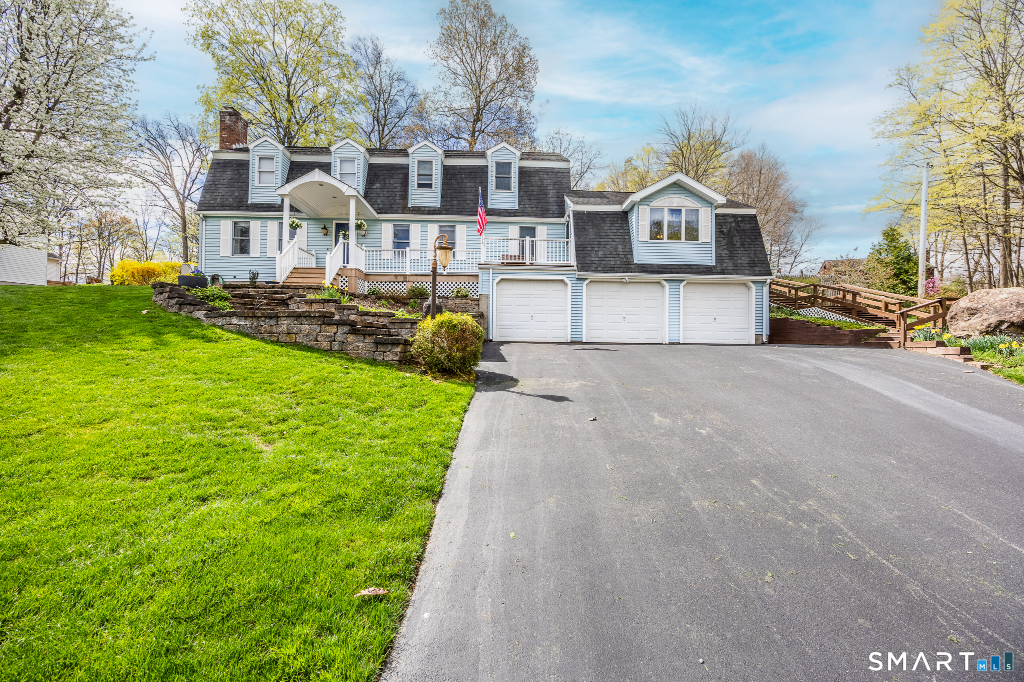 42 Chimney Sweep Road Wallingford, CT 06492 - Photo 2 of 40 a front view of a house with a garden and trees