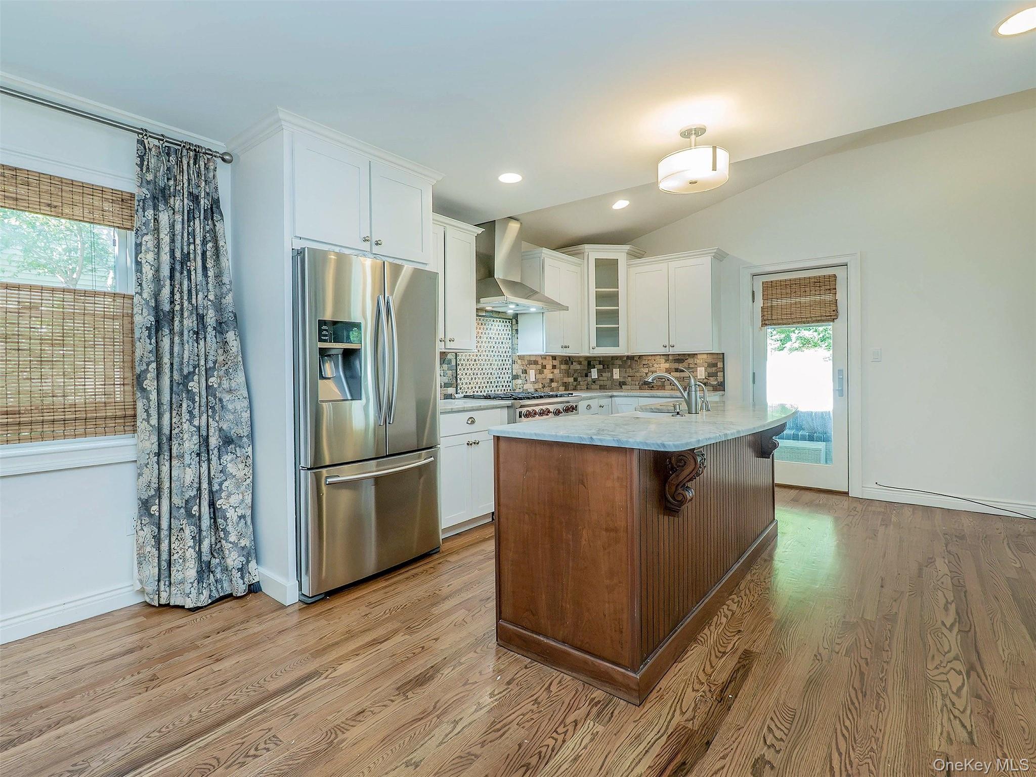 21 Marwood Road North Port Washington, NY 11050 - Photo 8 of 35 a kitchen with stainless steel appliances granite countertop a refrigerator a sink dishwasher and a stove with wooden floors