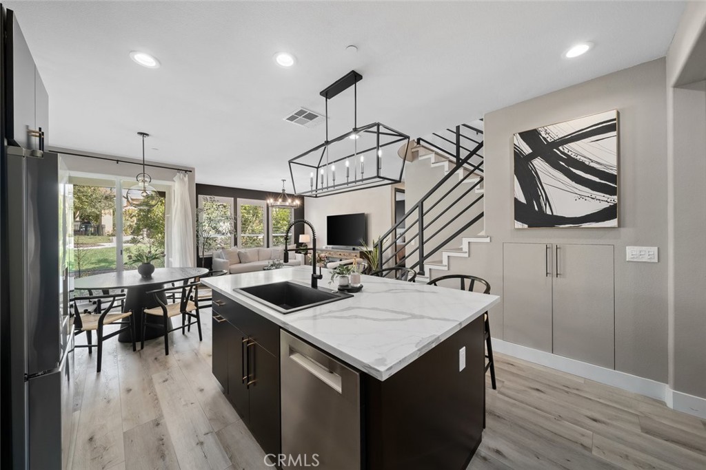 1177 Spring Azure Way, Unit 55 Nipomo, CA 93444 - Photo 14 of 75 a kitchen that has a sink a stove and a wooden floor