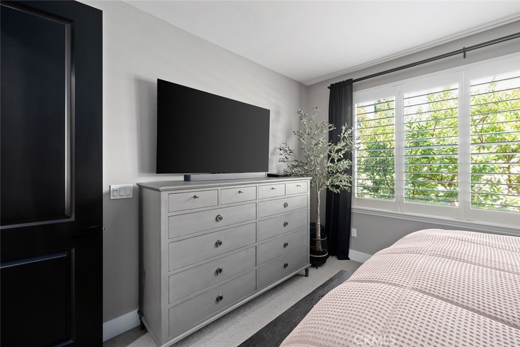 1177 Spring Azure Way, Unit 55 Nipomo, CA 93444 - Photo 23 of 75 a bedroom with a bed and a flat tv screen on dresser