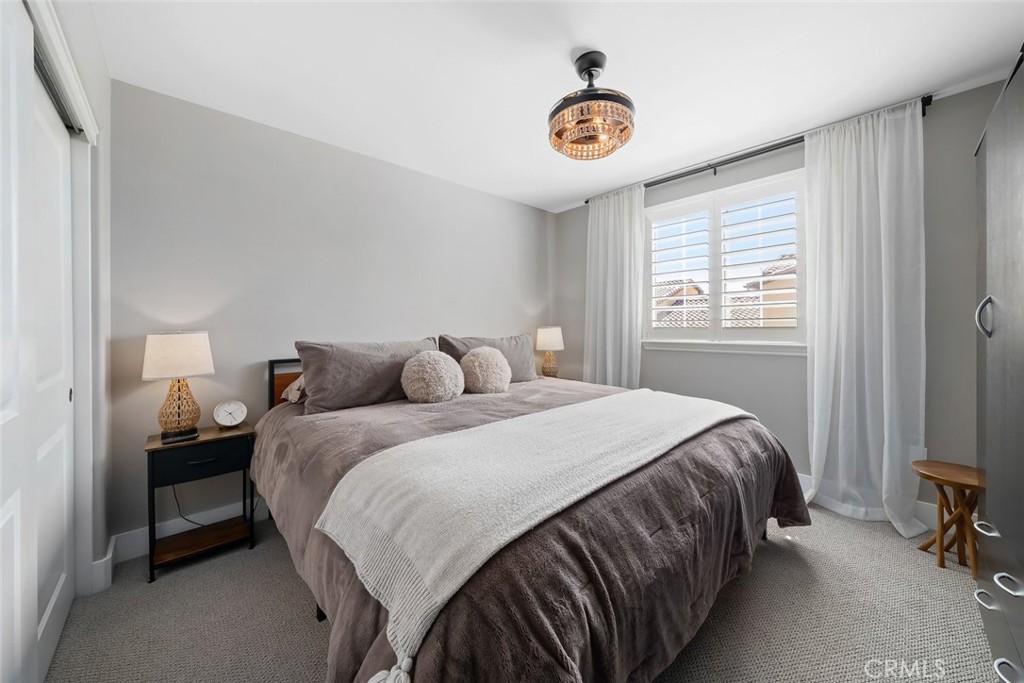 1177 Spring Azure Way, Unit 55 Nipomo, CA 93444 - Photo 34 of 75 a bedroom with a bed and a window